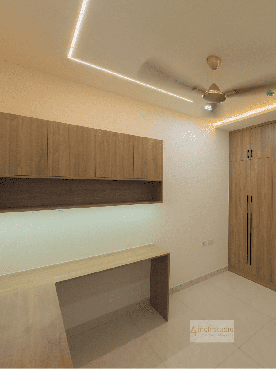 Study with floating wood shelf, slim desk, wardrobe and warm strip lighting in a Hyderabad apartment
