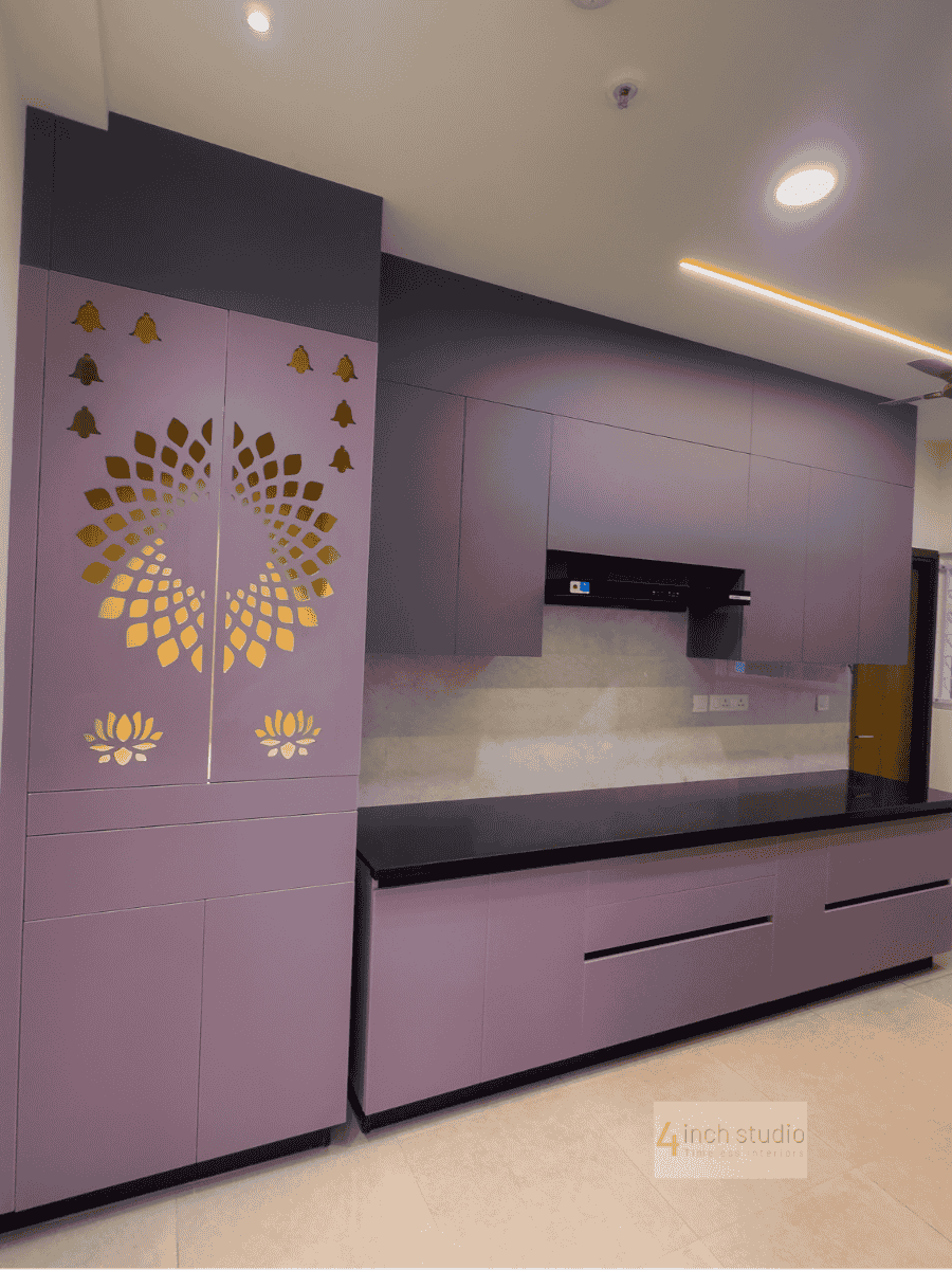 Mauve modular kitchen with gold lotus jali pooja unit, black granite counter and glossy cabinets, Hyderabad
