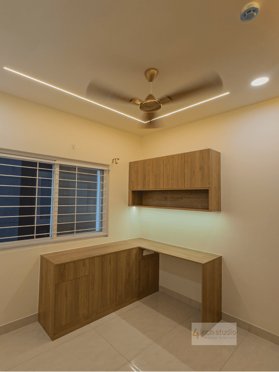Study corner with L-shaped wood desk, wall-mounted shelf, window and cove-lit false ceiling, Hyderabad