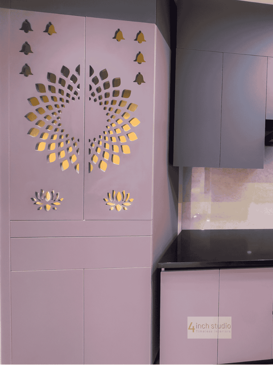 Lilac kitchen cabinet with CNC-cut lotus and sunburst motif beside grey overheads and black countertop, Hyderabad