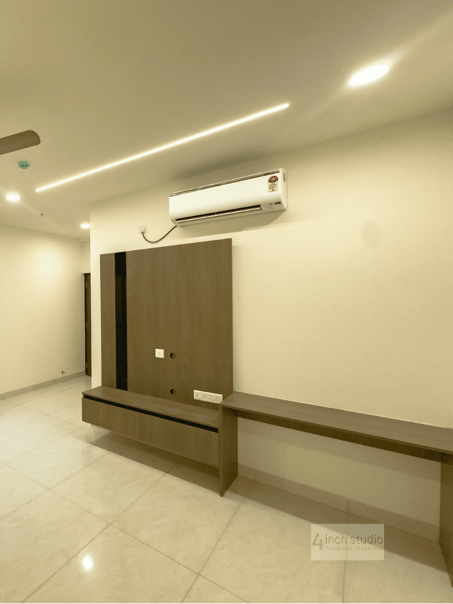 Wood TV panel with floating console and side desk, split AC and cove-lit ceiling in a bedroom, Hyderabad
