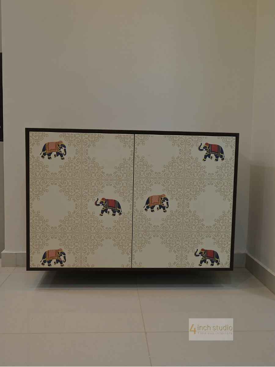 Cabinet doors in white with gold damask print and colourful caparisoned elephant decals, Hyderabad home