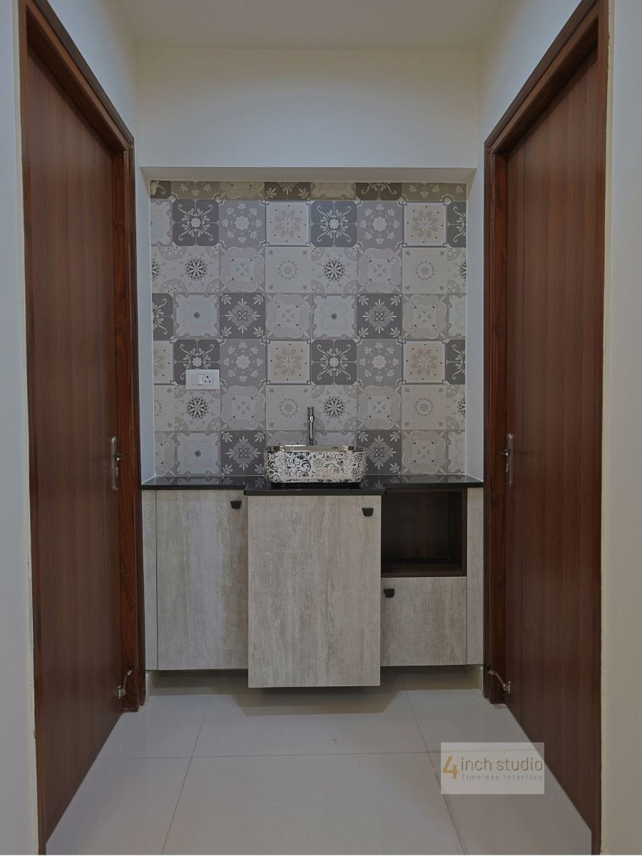 Washbasin nook with Moroccan-pattern tile backsplash and vessel sink flanked by teak doors, Hyderabad
