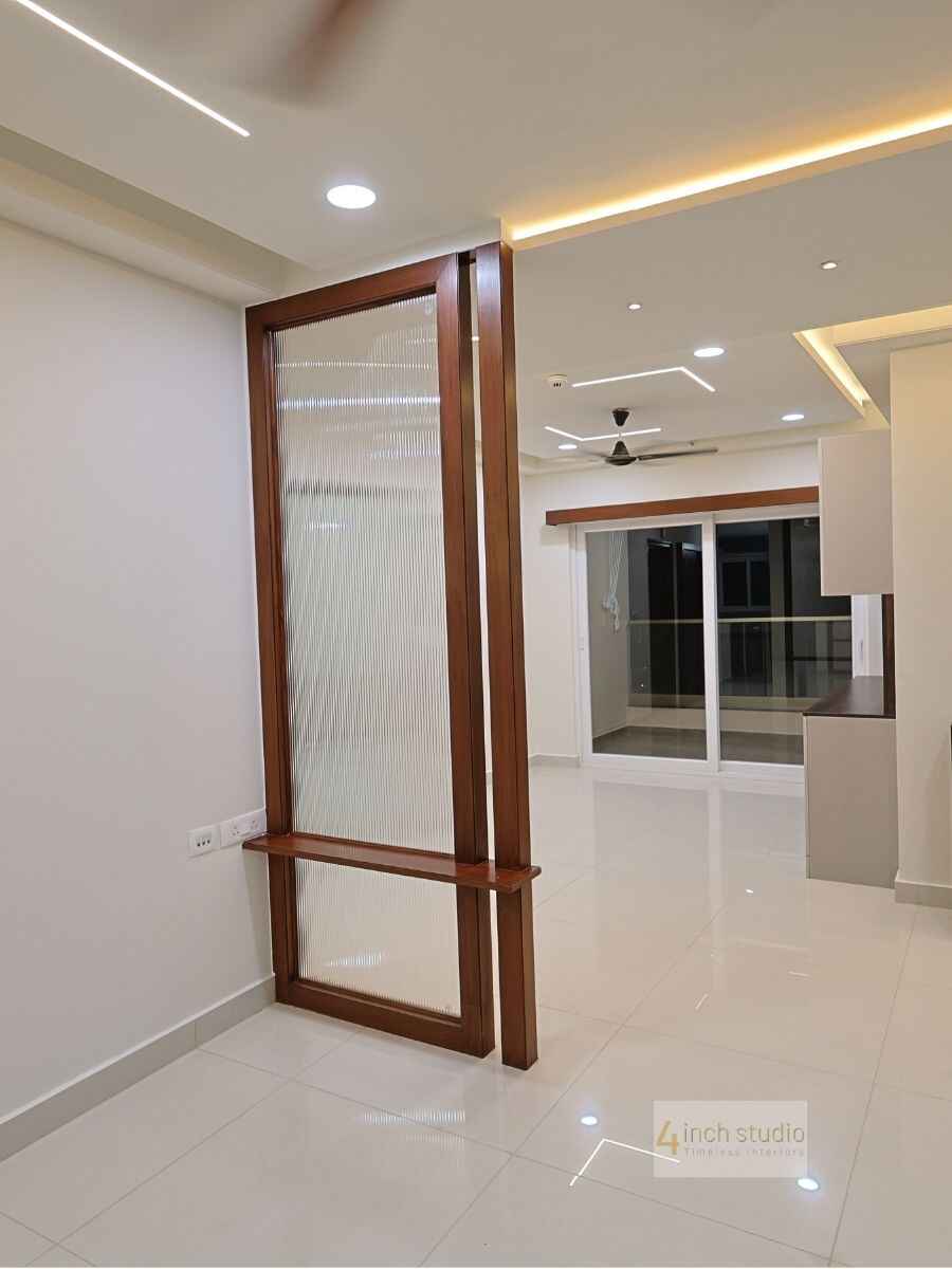 Entryway teak partition in reeded glass with built-in bench, glossy tiled floor and balcony beyond, Hyderabad
